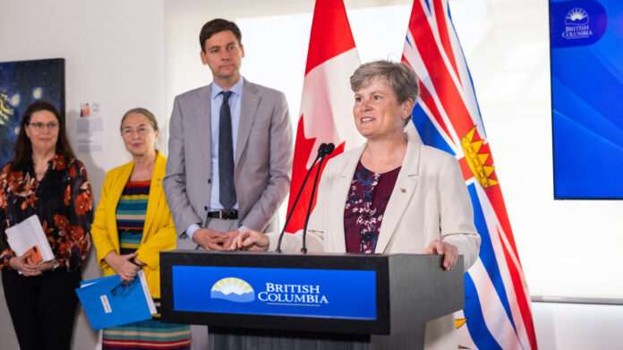 Photo of Health minister Josie Osborne making an announcement, alongside Premier David Eby