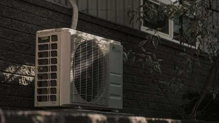 Photo of heat pump air conditioner outside a home.