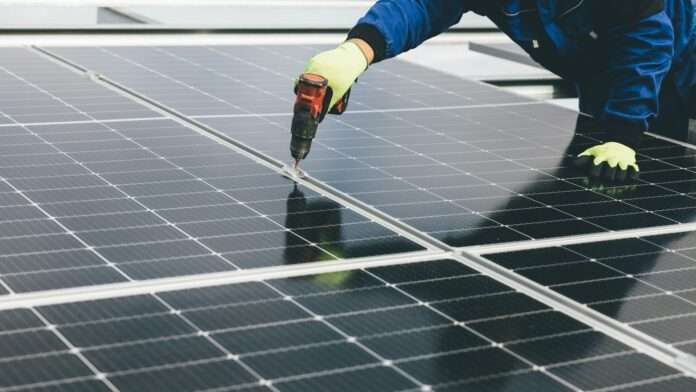 Stock photo of a worker installing solar panels