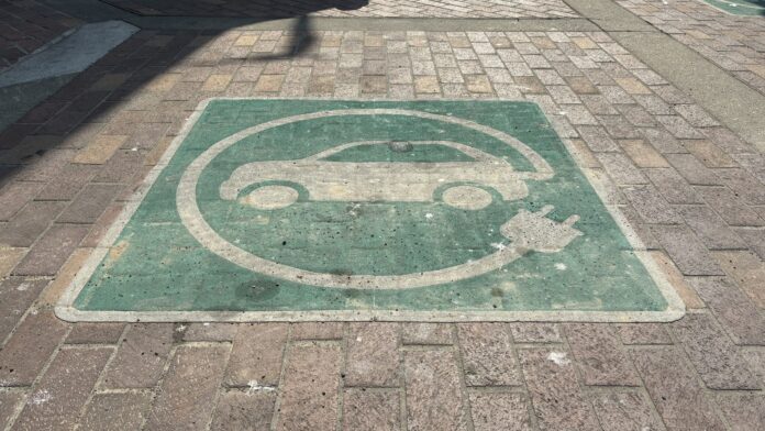 Photo of an EV charging symbol on a parking spot