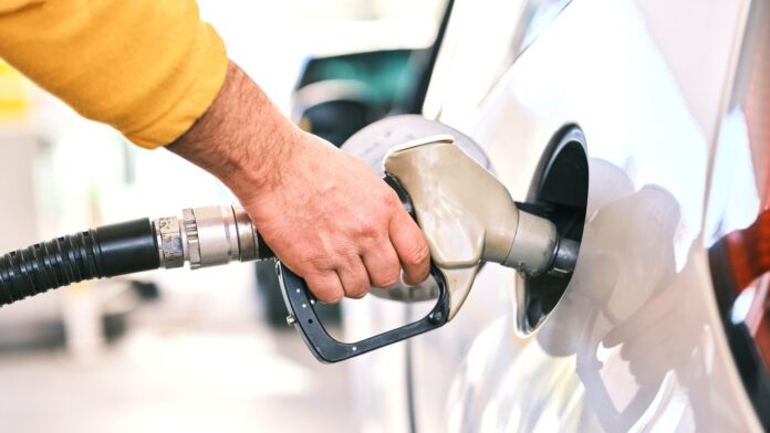 Close up photo of an individual pumping gas