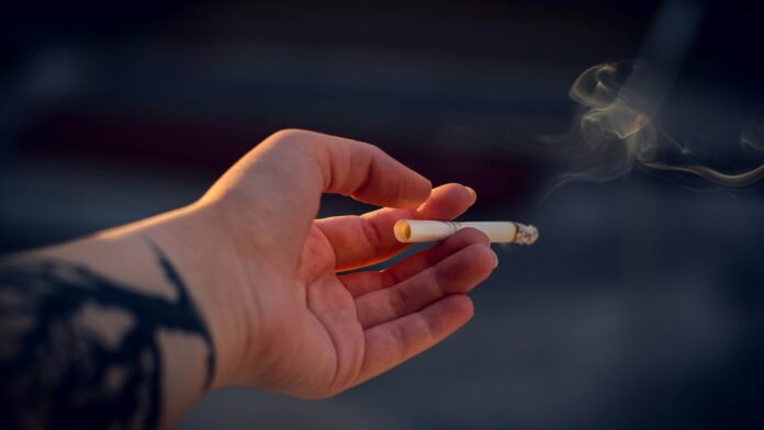 Photo of hand holding a cigarette