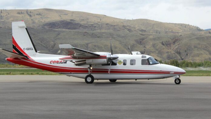 Photo (The birddog, TC-690, decends onto the tarmac of the Kamloops Airtanker Base.