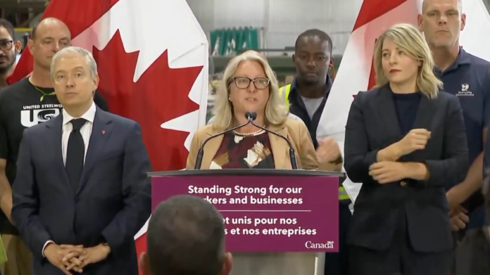 Ottawa-Vanier-Gloucester MP Mona Fortier, centre, joins Finance Minister François-Philippe Champagne, left, and Industry Minister Mélanie Joly during a news conference in Ottawa on Aug. 25, 2026. | Department of Finance Canada/X